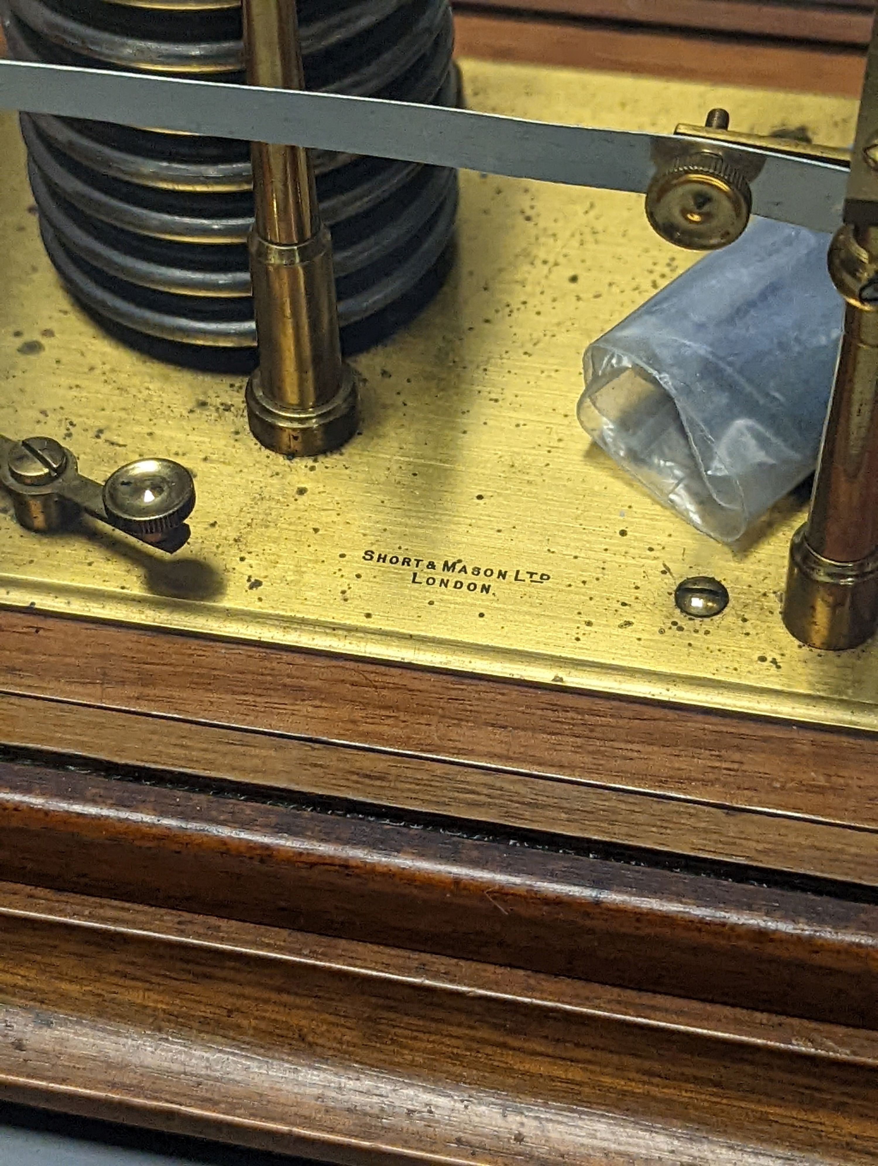 A Short & Mason oak cased barograph with spare graph paper